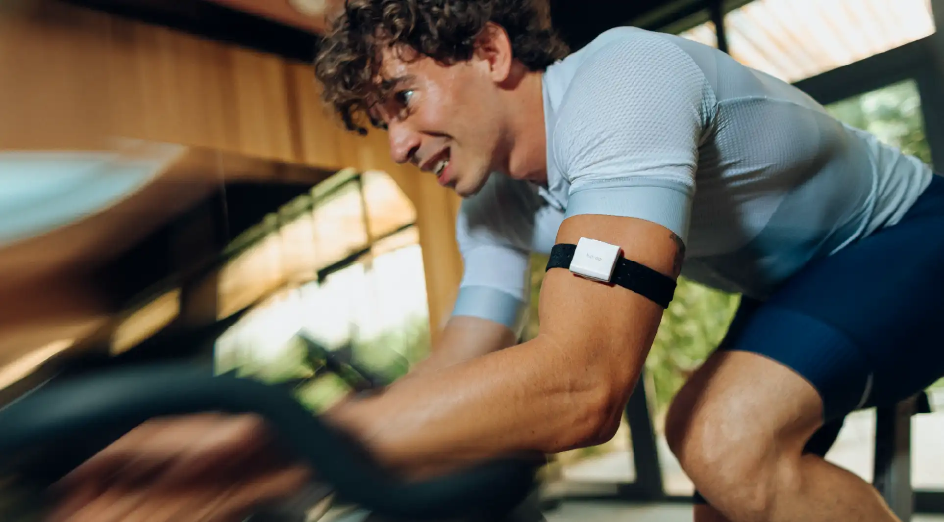 Athlete training indoors wearing hDrop Gen 2 on his upper arm