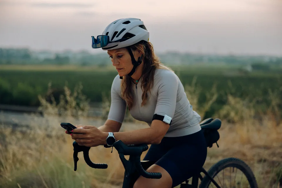Cyclist checking her phone while wearing hDrop