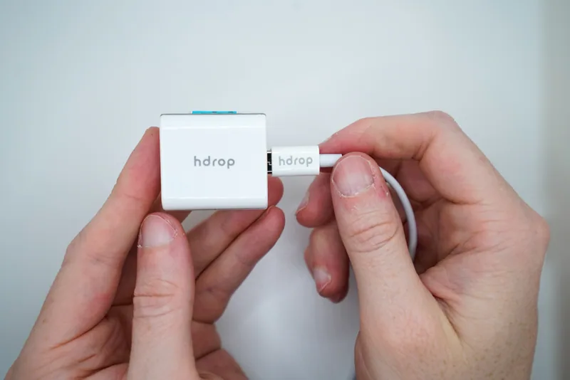 The real hDrop sensor connected to its USB charging cable