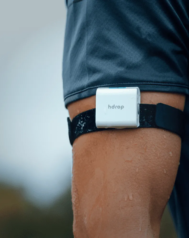 hDrop Gen 2 hydration sensor worn on the upper arm showing skin contact during activity
