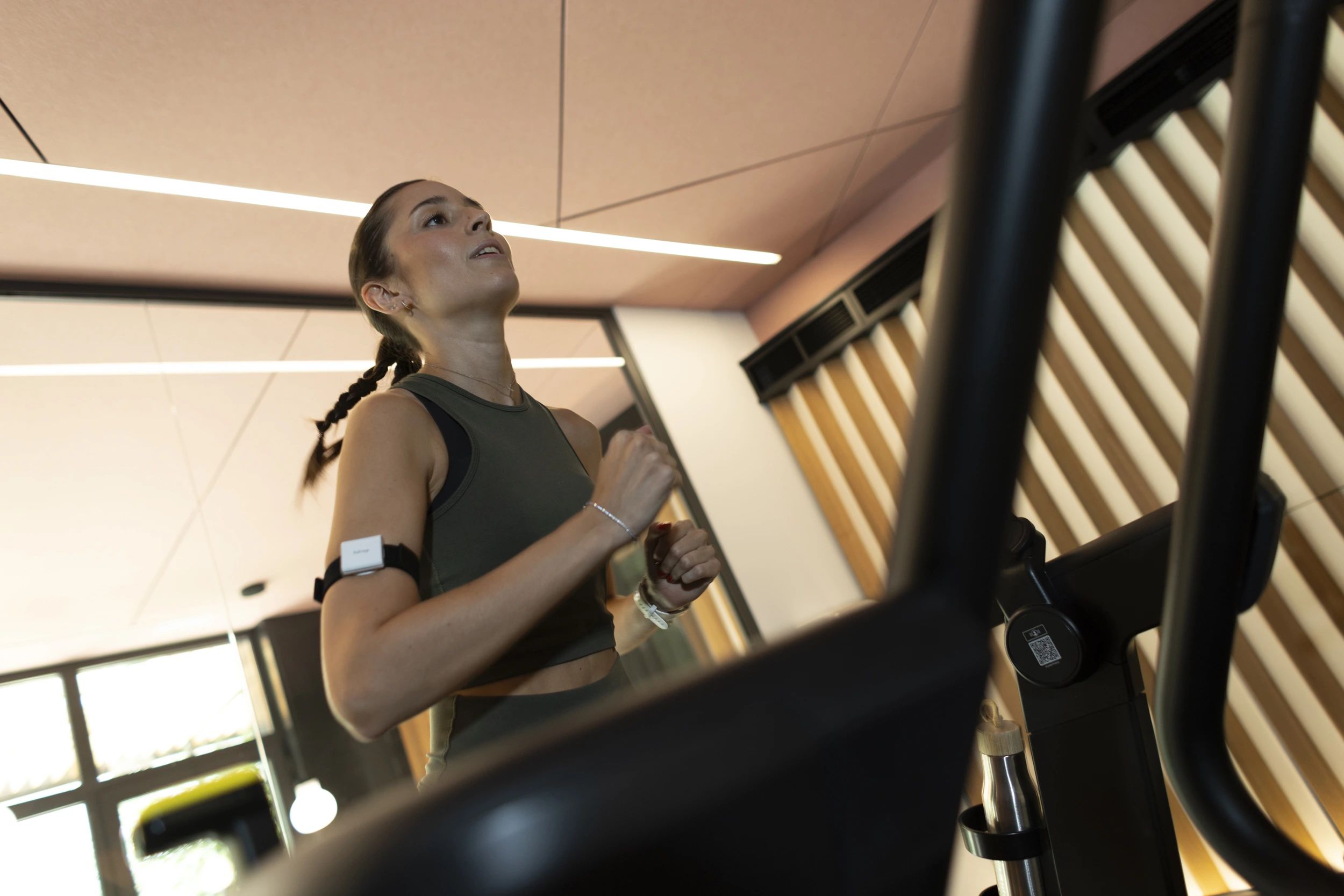 Athlete wearing an hDrop sweat sensor while training indoors on a treadmill